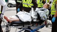 A woman is loaded into an ambulance after she was injured by one of two bombs at the Boston Marathon on April 15, 2013